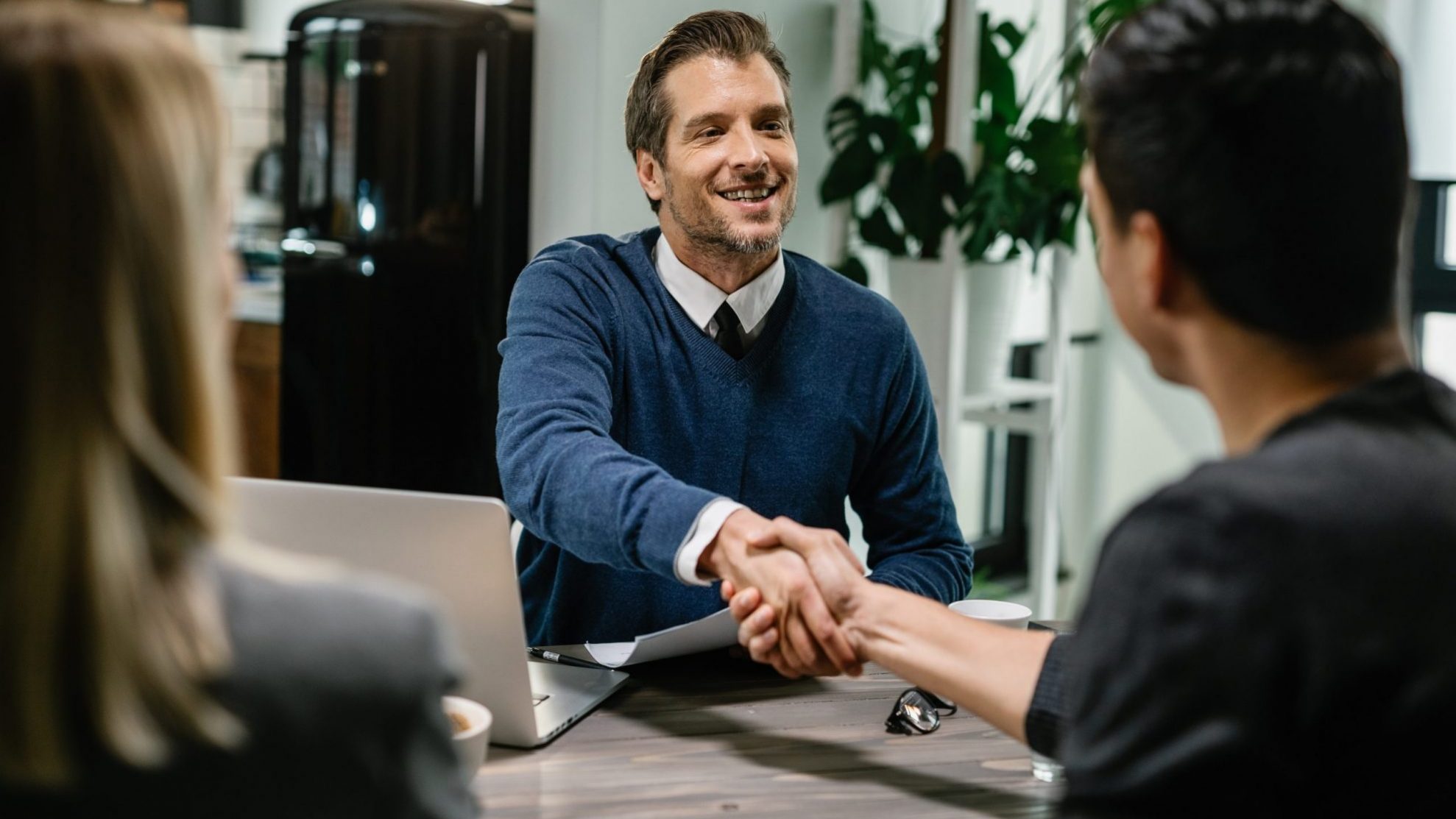 Photo of two men shaking hands illustrates blog "Commercial Real Estate: The Benefits of Seller Financing"