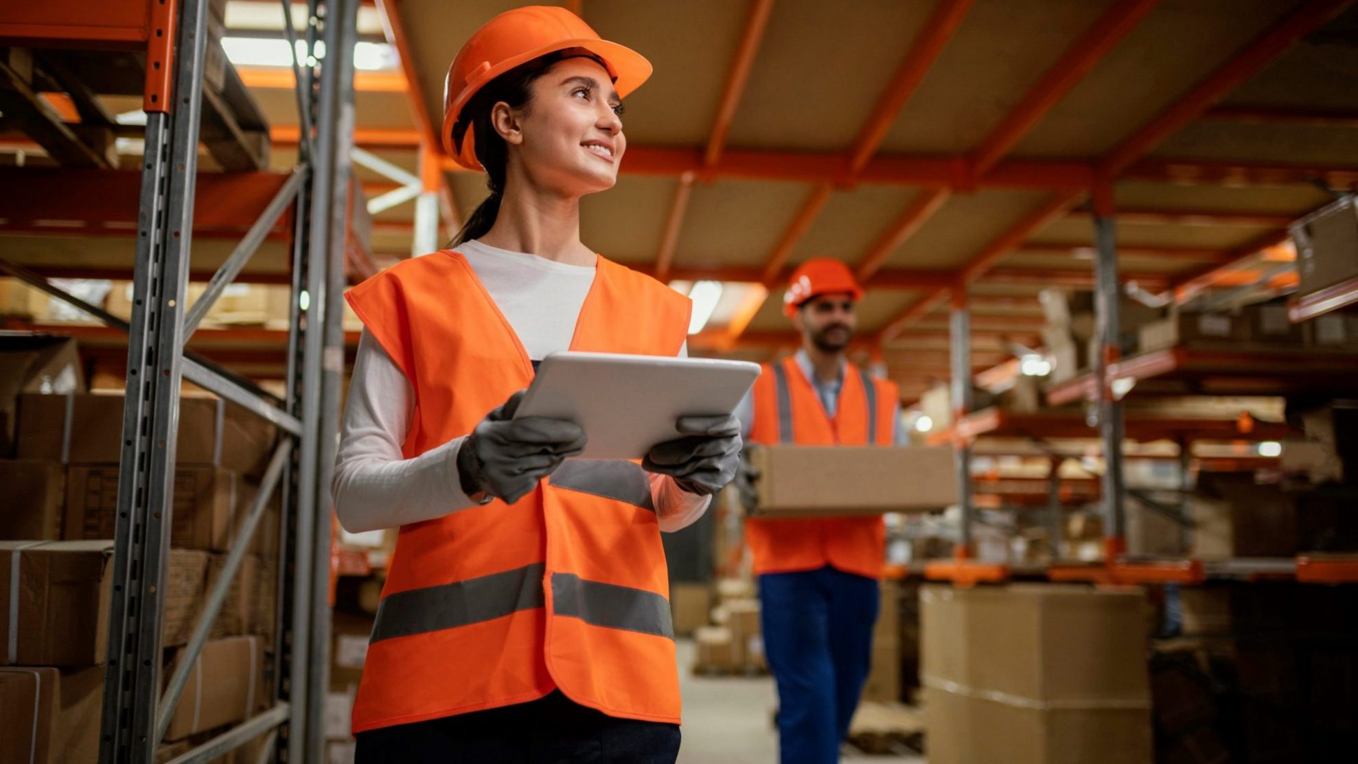 Photo of smiling woman wearing safety vest and hardhat illustrates blog "What Is Flex Industrial Space?"