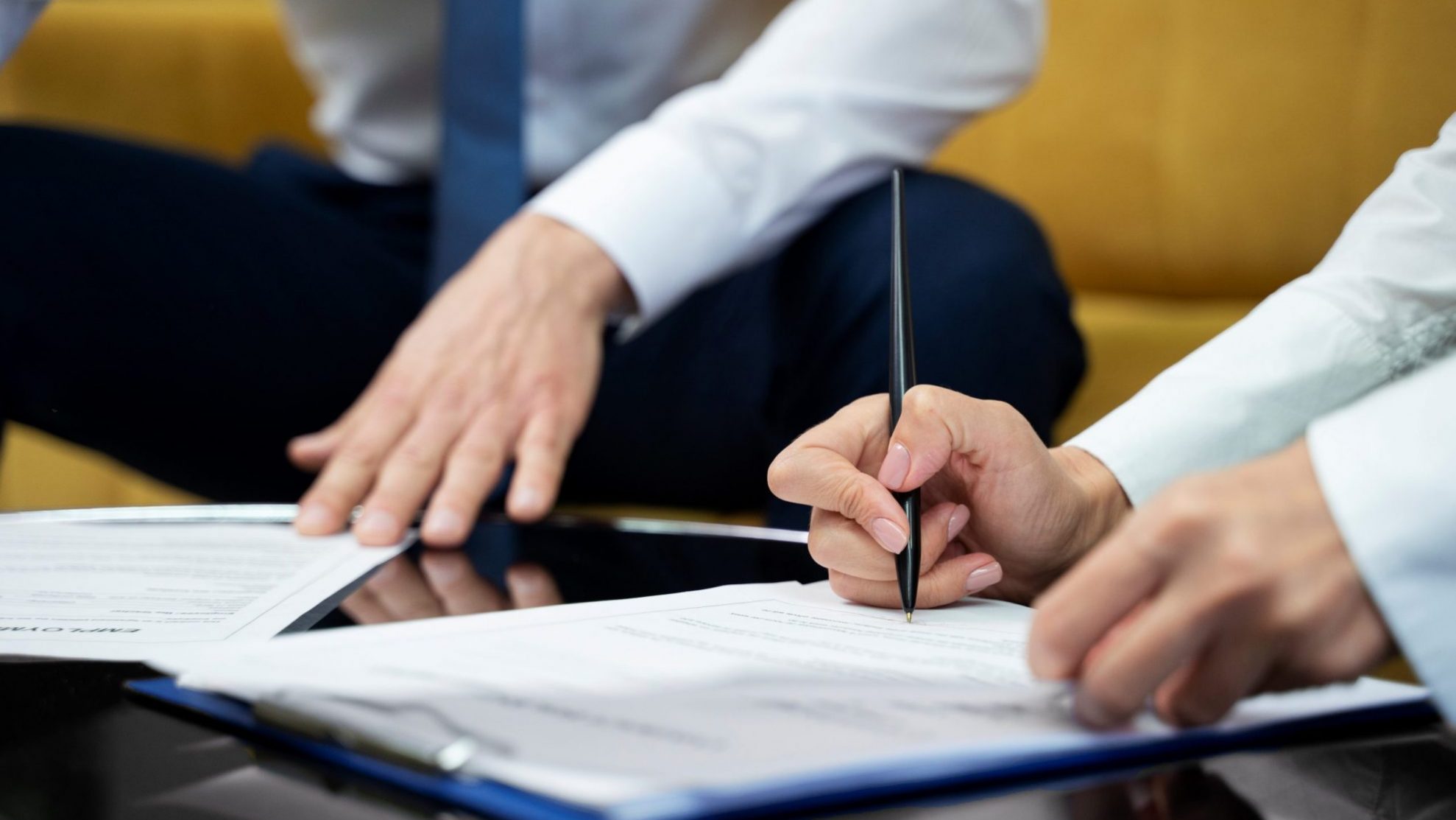 Closeup of person signing document illustrates blog "Commercial Real Estate: What Is a Letter of Intent?"