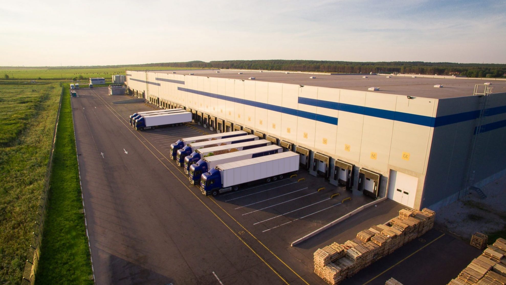 Distribution center with trucks parked outside illustrates blog "Reminder: L.A.’s “Mansion Tax” Kicks In April 1, 2023"